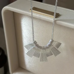 S925 sterling silver brushed fan pendant necklace displayed in cream leather jewelry box, artistic matte silver necklace for women