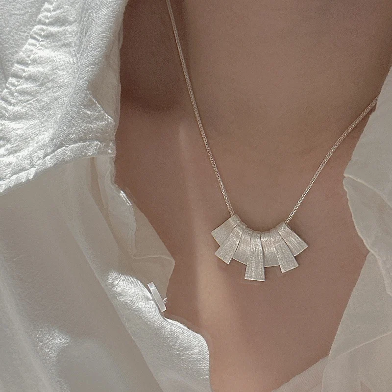 S925 silver fan shape pendant necklace worn on collarbone with white linen shirt, front view everyday styling