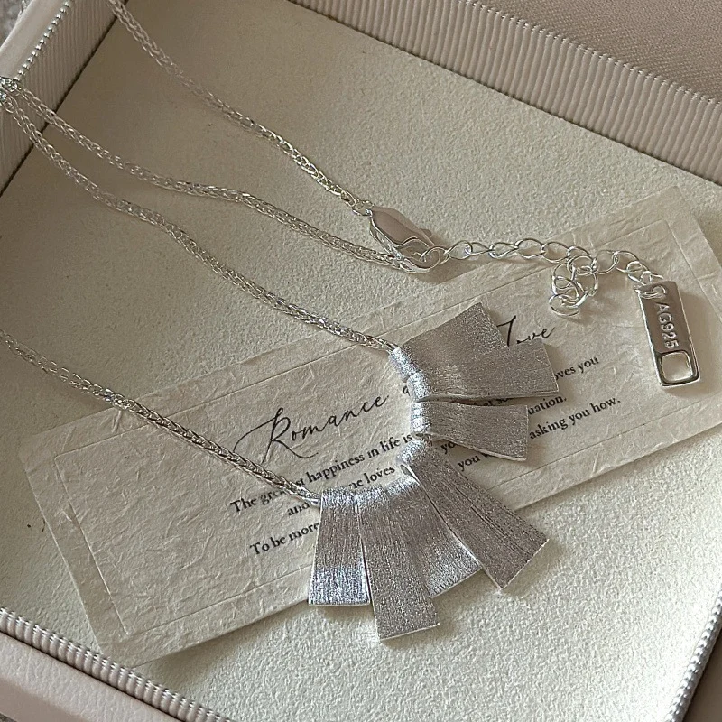 Close-up of S925 silver fan necklace lobster clasp, extension chain and AG925 marked tag