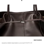Close up of drawstring toggle metal buckle on women soft brown leather tote bag, fine stitching detail