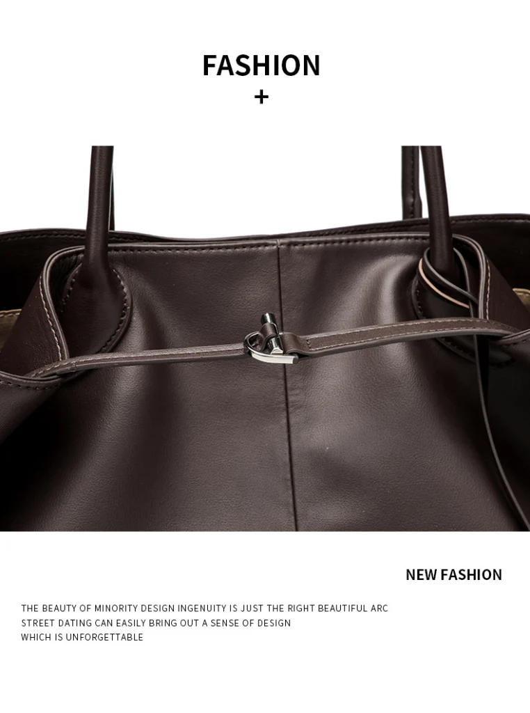 Close up of drawstring toggle metal buckle on women soft brown leather tote bag, fine stitching detail