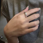High polished glossy curved silver statement ring worn on hand, chunky S925 sterling silver open ring