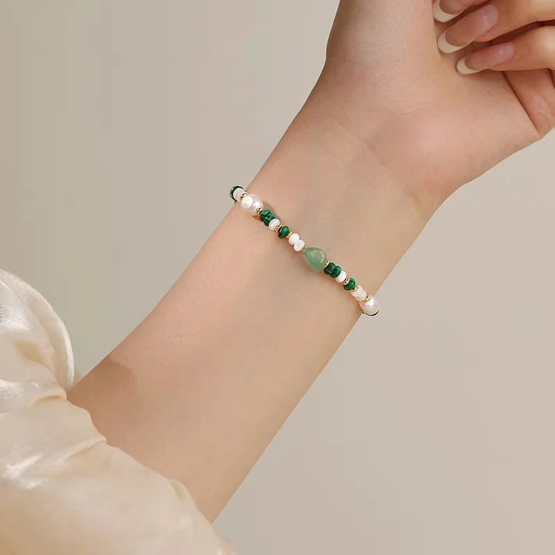 Close-up of natural freshwater pearl and crystal beaded necklace with PAT clasp detail, showing 6-7mm baroque pearls, malachite chips, aventurine ovals, white seed beads, and 18K gold-plated hardware and clasp mechanism by MAISON ELARA & CO