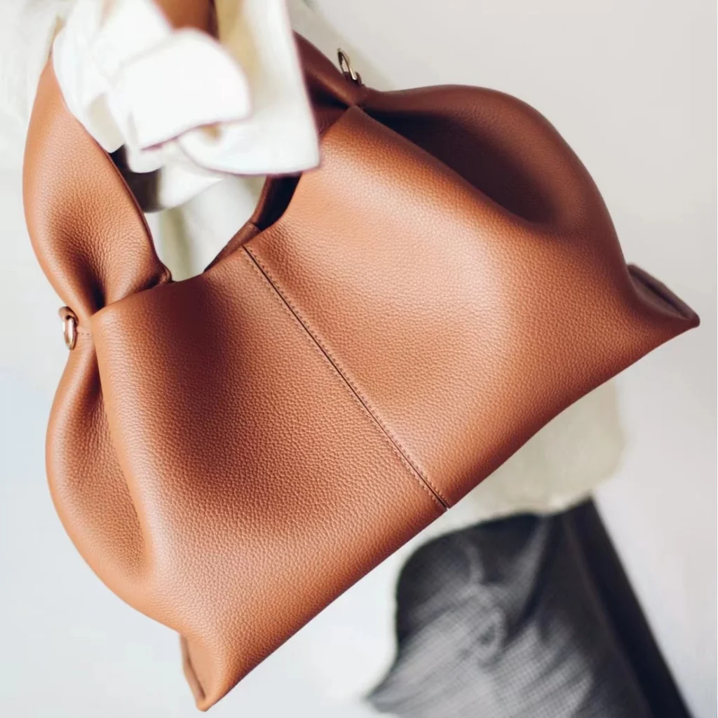 Dark brown suede cloud bag with black leather jacket, retro edgy vintage handbag styling