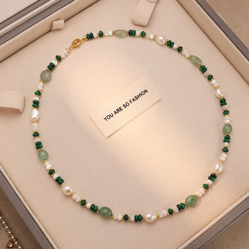 Close-up of natural freshwater pearl and crystal beaded necklace showing 5cm extended chain detail, featuring 18K gold-plated extension chain with clasp and baroque pearl and crystal bead strand by MAISON ELARA & CO