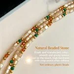 Colorful natural stone and shell beaded necklace photographed on a white background