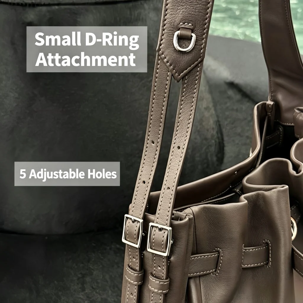 Close‑up of adjustable shoulder strap with D‑ring attachment for navy genuine leather hobo tote bag