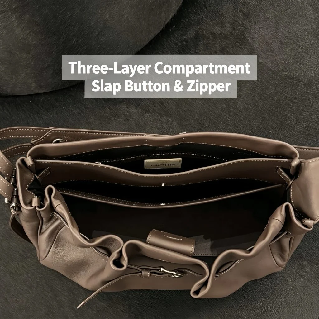 Open bag view showing three‑layer interior compartments with snap button and zipper for navy genuine leather hobo tote bag