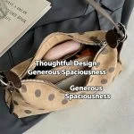Beige polka dot hobo bag styled on bed with book and glasses, spacious interior lifestyle shot