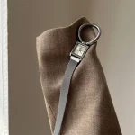 Close-up of the vintage silver square watch showing the oversized ring detail, mini square dial and magnetic mesh strap