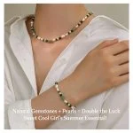 Model wearing natural freshwater pearl and crystal beaded necklace and bracelet set, wearing white button-down shirt, showing baroque pearls, malachite and aventurine beads, and 18K gold-plated hardware by MAISON ELARA & CO
