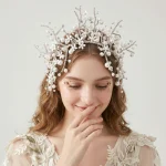 Bride model wearing handmade pearl flower rhinestone headband, romantic wedding hairstyle display