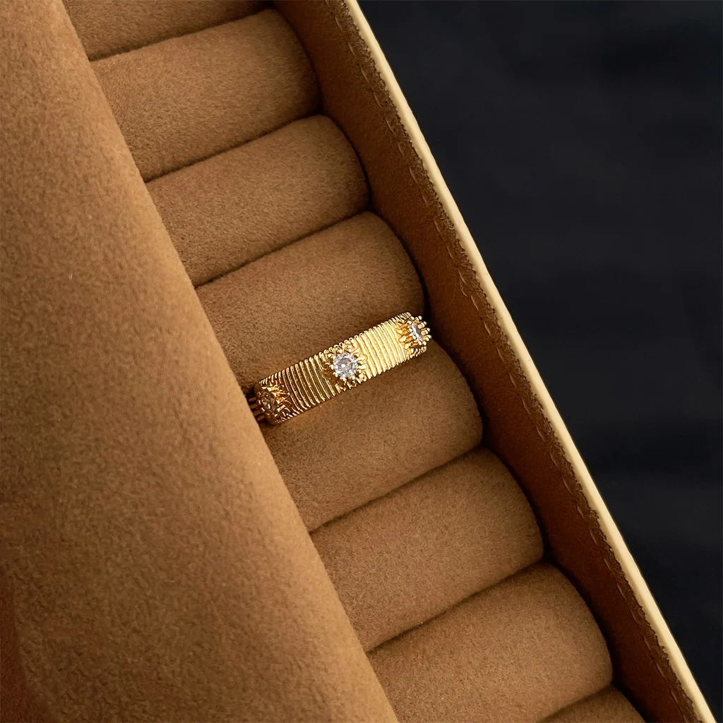 Vintage gold ring with dark gemstone in velvet jewelry box, palace style statement ring detail