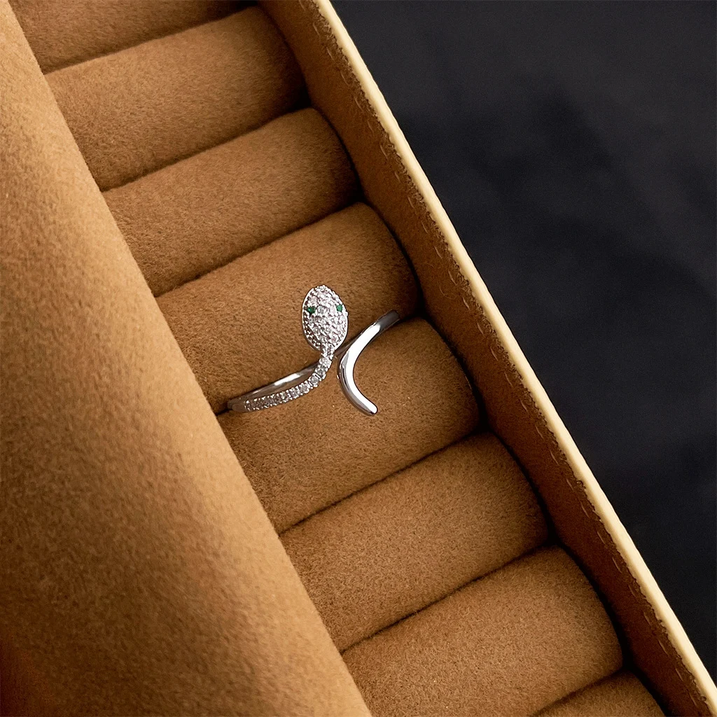 Vintage gold ring with dark gemstone in velvet jewelry box, palace style ring collection detail shot