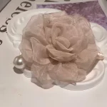 Faux pearl camellia clip close-up