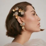 Short bob bride model wearing gold floral crystal hair clips, minimalist wedding hairstyle